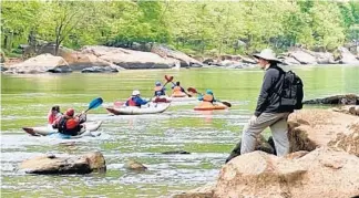  ??  ?? Kayaking on the New River can be a bit of a challenge for those used to calmer lake waters. But the words of wisdom are simple: Try to go with the flow.