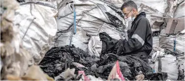  ?? Agence France-presse ?? A worker sorts through shredded plastic waste at a workshop in Cairo.