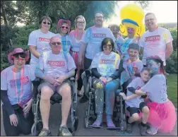  ??  ?? Claire Cunnington, took part in the Colourfun Mile in Hinckley in her wheelchair along with her husband Alan and their three children, 15 year-old Amelia, seven-year old Oliver and five-year-old Ben.