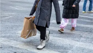  ?? Shelby Knowles/Bloomberg ?? A shopper carries a Zara bag in the Soho neighborho­od of New York in January. U.S. retail sales rose in February by less than forecast after a decline to start the year.