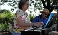  ?? Photos by Ryan Dahlman ?? Librarian Joan Côté was busy on the organ singing besides hosting the library book and DVD sale.