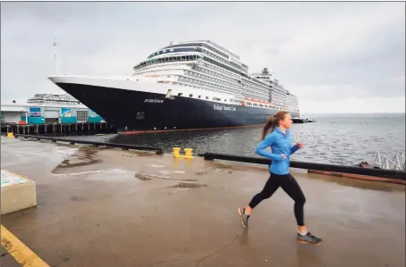  ?? Tribune News Service ?? A jogger passes in front of the Holland America Line cruise ship, MS Eurodam, docked and empty at the B Street Pier, on the Embarcader­o, in the afternoon in March in San Diego. The group that represents cruise lines with 95 percent of global ocean-going capacity said Tuesday its members have agreed to extend the suspension of U.S. sailing operations for the rest of 2020.