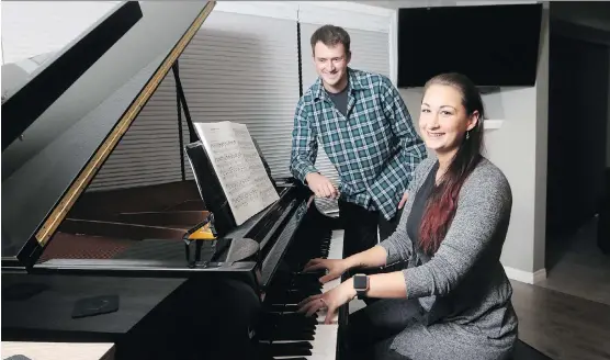  ?? CHRISTINA RYAN ?? Lisle and Alexandra Massey enjoy the spaciousne­ss of their new home — including room for the grand piano — in the Airdrie community of Southwinds