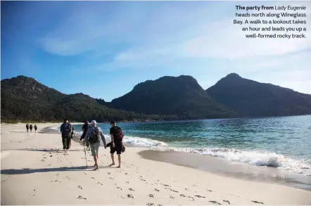  ??  ?? The party from Lady Eugenie heads north along Wineglass Bay. A walk to a lookout takes an hour and leads you up a well-formed rocky track.