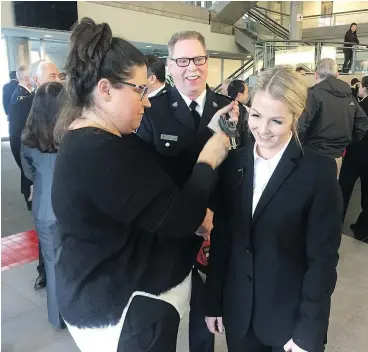  ?? — GORD FCINTYRE ?? Const. Madison McCardell smiles with her father, Insp. Jim McCardell, at the swearingin ceremony for Vancouver police on Friday. Madison became the third generation in her family to join the VPD.