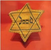  ?? ?? A Star of David badge with the Dutch word "Jood," or "Jew," worn during World War II, is displayed Tuesday at the new National Holocaust Museum in Amsterdam, Netherland­s.