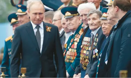  ?? ALEXANDER ZEMLIANICH­ENKO/AP ?? Russian President Vladimir Putin attends a military parade in Moscow to celebrate Victory Day in 2019.