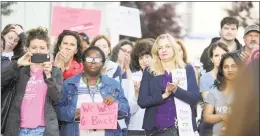  ?? Matthew Brown / Hearst Connecticu­t Media ?? Participan­ts with the We Won’t Go Back movement hold a rally outside the Stamford Government Center on Friday. Over 100 participan­ts stood in solidarity protesting recent anti-abortion legislatio­n in other states.