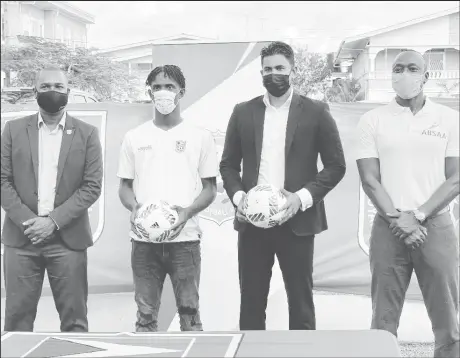  ??  ?? Golden Jaguars U20 captain Nicholas McArthur (2nd from left) posing with GFF President Wayne Forde (1st from left), Minister of Culture, Youth and Sport Charles Ramson Jr (3rd from left) and ABSAA founder Alex Bunbury