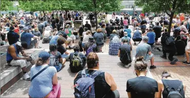  ?? MARSHALL GORBY / STAFF ?? Protesters have a moment of silence for George Floyd at Dayton’s Courthouse Square on Saturday. The gathering downtown went more calmly than the previous Saturday’s events in Dayton.