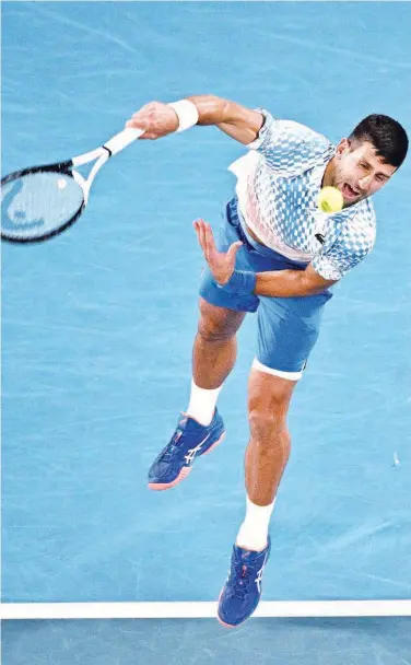  ?? Agence France-presse ?? Novak Djokovic serves against Enzo Couacaud during their singles match on day four of the Australian Open in Melbourne on Thursday.