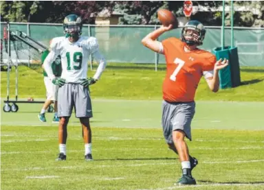  ??  ?? Colorado State quarterbac­k Nick Stevens delivers a pass while wide receiver Sammie Long observes during practice Wednesday in Fort Collins. Michael Brian, Loveland Reporter-Herald