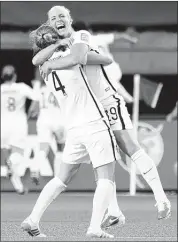  ?? ADRIAN WYLD/THE CANADIAN PRESS VIA ASSOCIATED PRESS ?? Americans Becky Sauerbrunn (left) and Julie Johnston celebrate Carli Lloyd’s goal against China during the second half of the 1-0 U.S. victory Friday in Ottawa, Ontario.