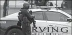  ?? JAE S. LEE/THE DALLAS MORNING NEWS ?? An Irving police officer works at the shooting scene on the North Lake College campus on Wednesday in Irving, Texas.