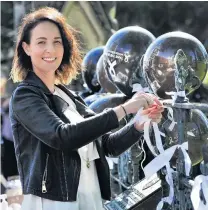  ?? PHOTOS: CHRISTINE O’CONNOR ?? Stamping out family harm . . . Arai Te Uru Whare Hauora family violence social worker Sophie Taele celebrates White Ribbon Day outside Dunedin’s First Church yesterday.