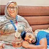  ?? —
PTI ?? Manpreet Singh, captain of the bronze medal winning Indian men’s hockey team, rests in his mother’s lap at their residence in Jalandhar on Wednesday.