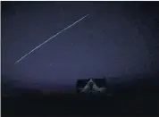  ?? REED HOFFMANN — THE ASSOCIATED PRESS ?? A string of SpaceX StarLink satellites passes over an old stone house near Florence, Kan., on Thursday.