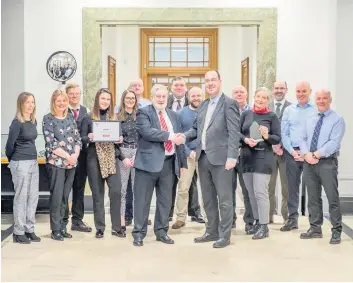  ??  ?? Winners
Cllr Tom Conn and Craig Smith, with staff from the council’s Environmen­tal Health team