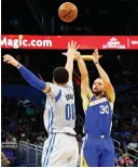  ?? (Reuters) ?? GOLDEN STATE WARRIORS guard Steph Curry (30) shoots over Orlando Magic defender Aaron Gordon for one of his seven made three-pointers in the Warriors’ road triumph on Sunday night.