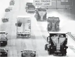  ?? GERRY BROOME/AP ?? Vehicles navigate hazardous interstate conditions Sunday as a storm moves through Mebane, N.C. Two people died when their car drove off the road east of Raleigh.