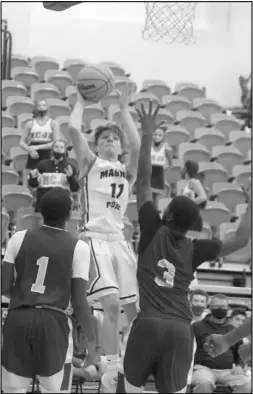  ?? Photo by Gerren Smith ?? GAME WINNING BASKET: Hayden Browning (11) floats up a shot over the Mineral Springs defense to score the game winning basket from transition to propel the Magnet Cove Jr. Panthers in victory 39-38 Tuesday.