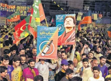  ?? AP PHOTO ?? Pakistan Tehreekein­saf party (PTI) supporters celebrate the projected results announced by the media indicating the success of the party’s candidates in the parliament­ary elections in Pakistan on Wednesday.