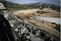  ?? MAJDI MOHAMMED/ASSOCIATED PRESS ?? Burned cars are seen in the town of Hawara, near the West Bank city of Nablus, Monday, Feb. 27, 2023. Scores of Israeli settlers went on a violent rampage in the northern West Bank, setting cars and homes on fire after two settlers were killed by a Palestinia­n gunman. Palestinia­n officials say one man was killed and four others were badly wounded.