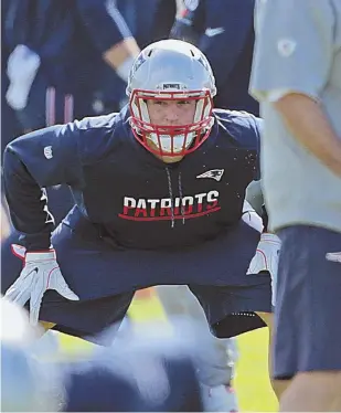  ?? STAFF PHOTOS BY JOHN WILCOX ?? MAKING PROGRESS: Rob Gronkowski stretches yesterday before practice, where the tight end was a limited participan­t after sitting out on Wednesday.