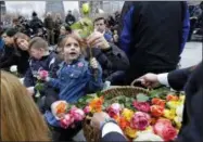  ?? RICHARD DREW— THE ASSOCIATED PRESS ?? Victoria Rossilli, grand daughter of Stephen Knapp, one of the six victims of the World Trade Center bombing, gets a rose to place on the 9/ 11Memorial, during the 25th anniversar­y ceremony of the event, in New York, Monday.