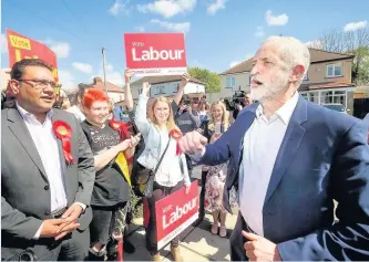  ??  ?? FIRED-UP Jeremy Corbyn ordered activists to “go for it” as he visited a Tory marginal on the first weekend of Labour’s “flying start” election campaign.
Mr Corbyn was mobbed and met with cheers from around 100 party activists knocking on doors and...