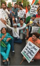  ?? — PTI ?? Congress workers protest against the unchecked rise in the prices of petrol and diesel in New Delhi on Tuesday.