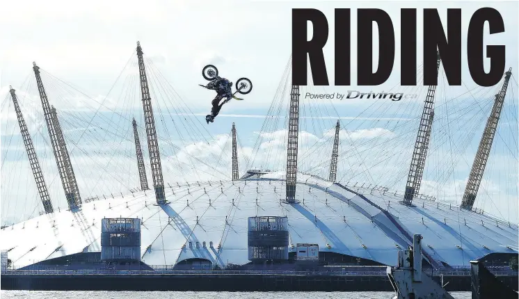  ?? — PHOTOS: THE ASSOCIATED PRESS ?? Daredevil Travis Pastrana performs a motorcycle backflip between two barges on London’s River Thames in front of the Millennium dome in 2017.