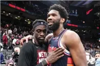  ?? Frank Gunn/the Canadian Press via AP ?? ■ Toronto Raptors forward Pascal Siakam, left, and Philadelph­ia 76ers center Joel Embiid, right, embrace Thursday after Game 6 of an NBA basketball first-round playoff series in Toronto.