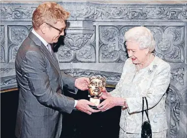  ??  ?? Appearance ‘‘sensationa­l’’: Sir Kenneth Branagh presents the Queen with an honorary Bafta in recognitio­n of a lifetime’s support for British film and television.