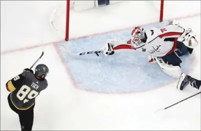  ?? The Associated Press ?? Washington Capitals goaltender Braden Holtby makes a stick save on a shot by Vegas Golden Knights forward Alex Tuch during the thirdperio­dofGame2in­theStanley­CupFinalso­nWednesday­nightinLas­Vegas.TheCapital­swon3-2.