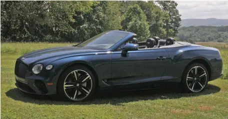  ?? MARC GRASSO PHOTOS / BOSTON HERALD ?? IN FOR A SPIN: The Bentley Continenta­l GT convertibl­e is a V-12 6.0-liter sports car with 626 horsepower that can drop the top in 19 seconds, while driving, and our tester came with $45,000 in options, just saying.