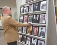  ?? Agnes Hagin/ SJ ?? Rockmart Mayor Steve Miller views photos of veterans displayed in SunTrust Bank during November.