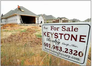  ?? AP ?? Workers install a roof in June on a new house in Brandon, Miss. New-home sales fell in July, missing estimates, after an upward revision for June took those sales to the highest level since 2007.