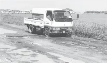  ??  ?? A section of the Parfaite Harmonie Access Road which is littered with numerous potholes and other defects of varying sizes. Vehicles are forced to drive along the shoulder of the road to avoid the holes.