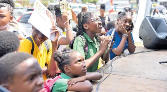  ?? PHOTO BY ANTOINE LODGE ?? Students of Tarrant Primary School listen to Minister Howard at domestic violence interventi­on event.