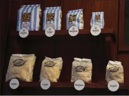  ?? ANTONIO PEREZ — CHICAGO TRIBUNE ?? Assorted sizes of popcorn are on display at Garrett Popcorn Shops in Chicago. Since at least the 1870s, Chicago has been a hotbed of popcorn innovation.