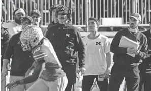  ?? ADAM CAIRNS/COLUMBUS DISPATCH ?? Michigan coach Jim Harbaugh watches from the sideline beside off-field analyst Connor Stalions during last year’s game vs. OSU.