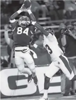  ?? Cathleen Allison, The Associated Press ?? Nevada’s Jerico Richardson attempts to catch a pass near the end zone against Colorado State’s Bernard Blake on Saturday night.