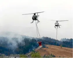  ?? MARTIN DE RUYTER/STUFF ?? Helicopter­s are dumping between 30 and 50 monsoon bucketload­s of water a day.