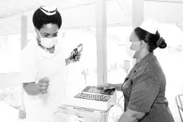  ?? ?? The National Chest Hospital has been named as one of the beneficiar­ies for the 2024 Sagicor Sigma ‘Honour Run’ slated for Sunday, February 18, in New Kingston. From left: National Chest Hospital staff nurses Tennesh Dillion and Andrene Morrison examine a respirator­y machine used for treating patients.