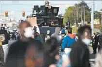  ?? KYLE TELECHAN/POST-TRIBUNE ?? An armored Lake County police vehicle follows behind protesters as they make their way down U.S. 30 in Hobart on May 31.