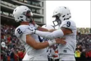  ?? PATRICK SEMANSKY — THE ASSOCIATED PRESS ?? Penn State quarterbac­ks Tommy Stevens, left, and Trace McSorley celebrate Stevens’ first-half touchdown during Saturday’s win over Maryland in College Park, Md.