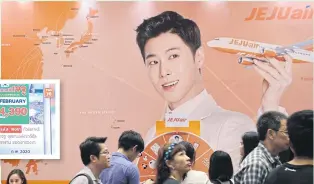  ?? WORRAPON PHAYAKUM ?? An ad for Jeju Air. Amid the coronaviru­s outbreak, operators are offering cheap tour packages to high-risk countries like South Korea.