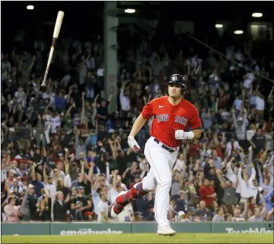  ?? MARY SCHWALM — THE ASSOCIATED PRESS ?? Fans cheer as the Red Sox’s Hunter Renfroe tosses his bat after hitting a three-run home run during the seventh inning of Boston’s win over the Indians.
