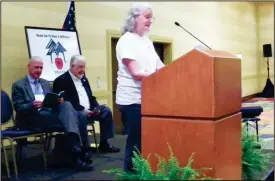  ?? CONTRIBUTE­D PHOTO ?? Mary Nell Podgorny at microphone, leading a song written by Reva Utz for the GREA Area meeting held in Calhoun in October 2016 to expound on the State Theme “Reach Out to Make a Difference.”